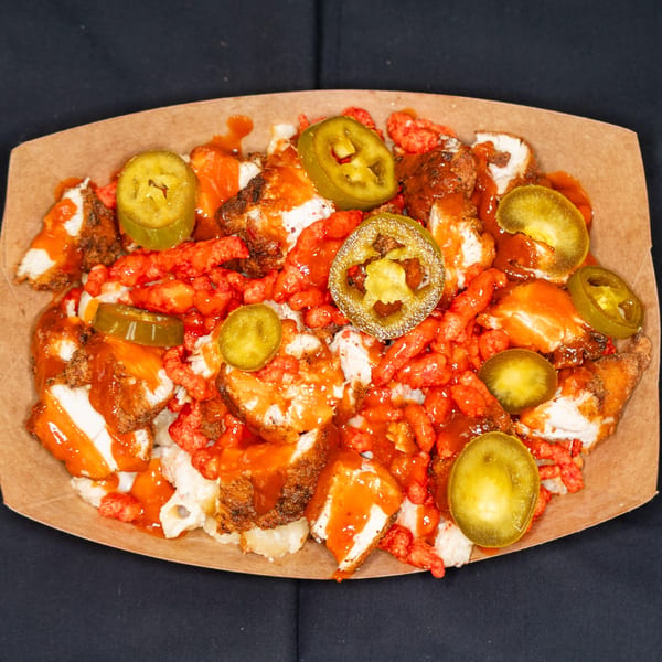 Jackpot's spicy chicken and mac and cheese dish, topped with jalapeños and hot sauce.